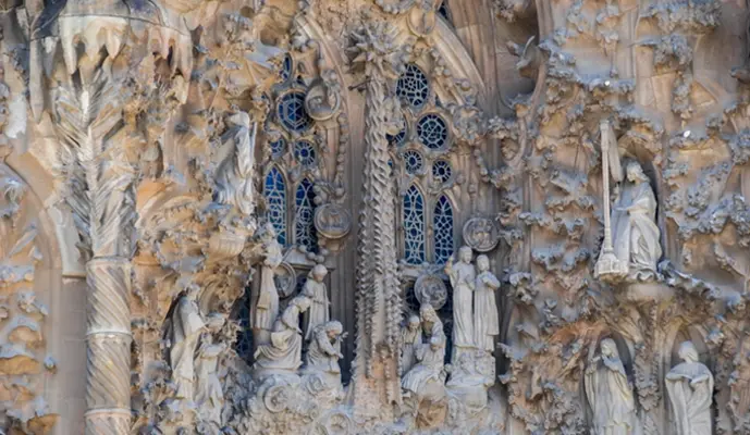 The intricate facade of Sagrada Familia, showcasing its unique architectural details and towering spires.