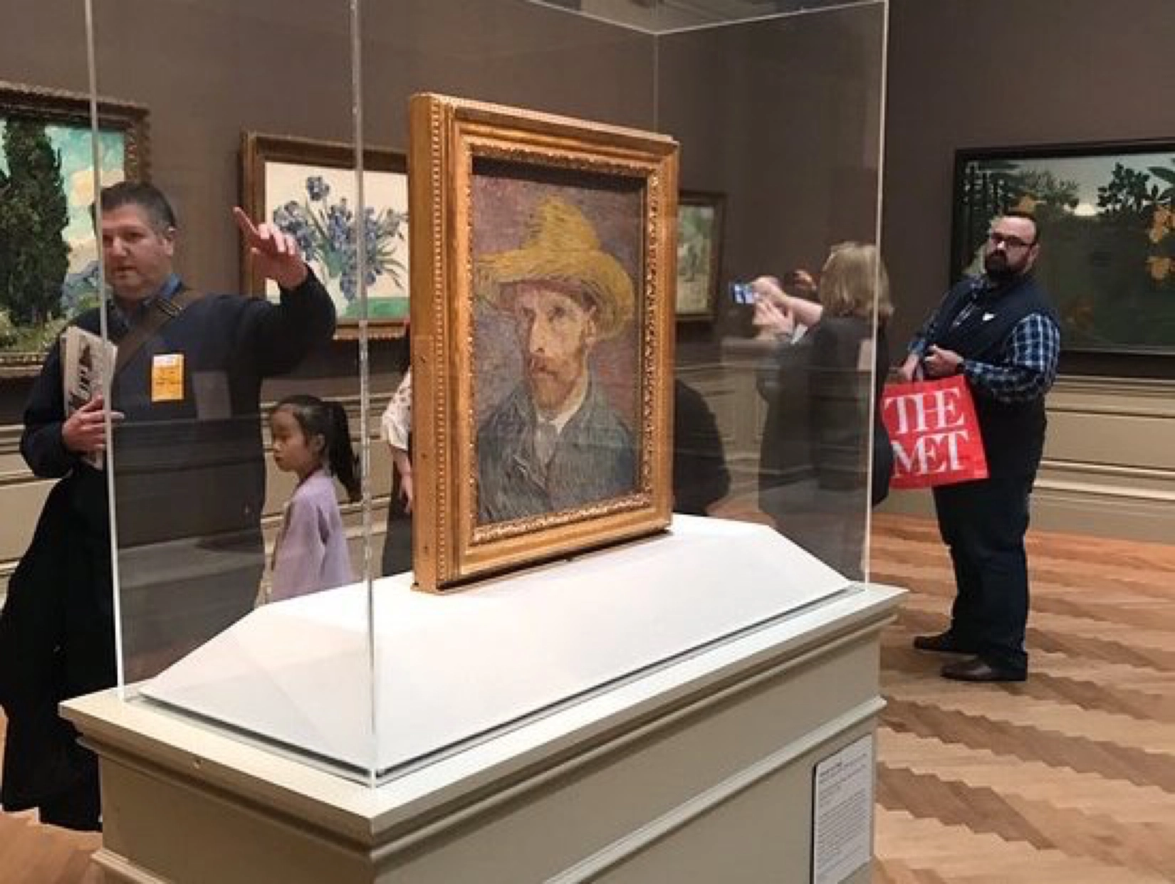 Vincent van Gogh's "Self-Portrait with Straw Hat" displayed in a glass case at the MET.