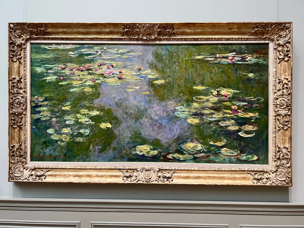 Claude Monet's painting "Water Lilies" displayed on a wall in the Metropolitan Museum of Art.